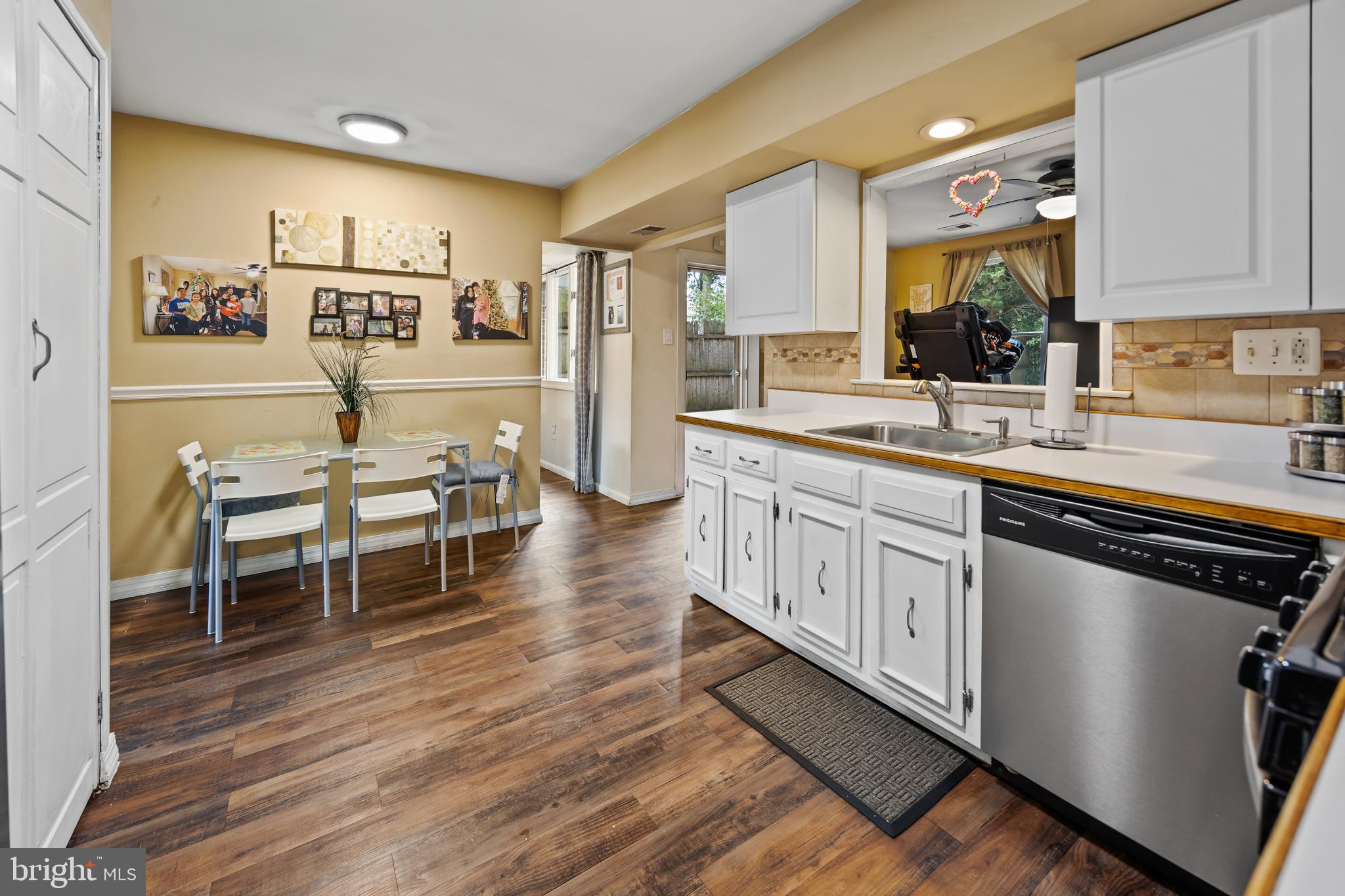 1715 Willow Place Clementon, NJ 08021 - Photo 12 of 37 a kitchen with stainless steel appliances sink cabinets and wooden floor