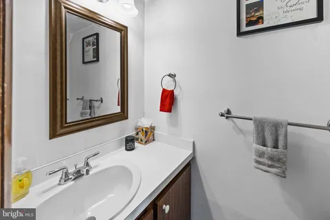 a bathroom with a sink vanity and mirror