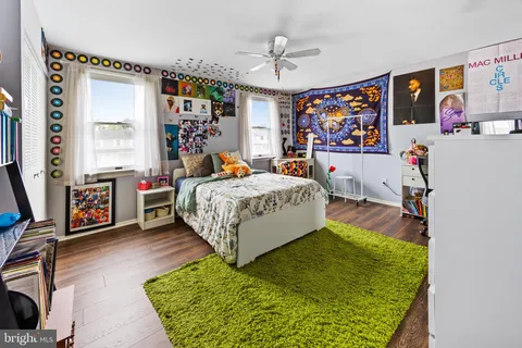 a bed room with a bed window and a flat screen tv