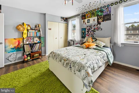 a bed sitting in a bedroom next to a window