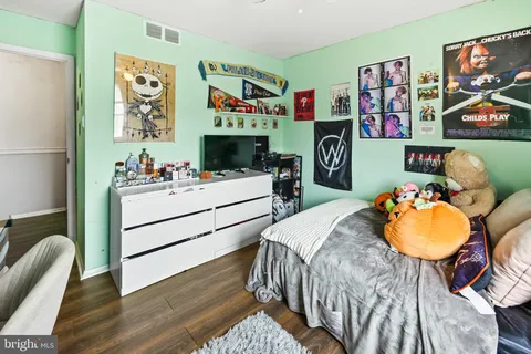 a bedroom with bed and a workspace