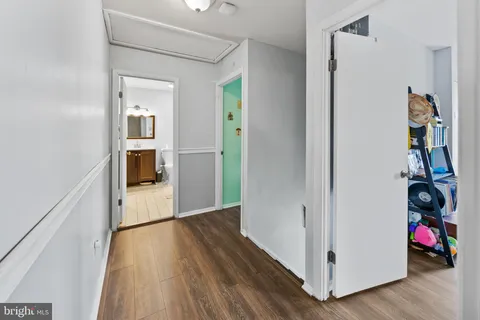 a view of hallway with wooden floor and stairs