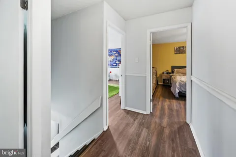 a view of a hallway to a livingroom and a hallway