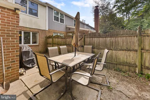 a backyard of a house with table and chairs