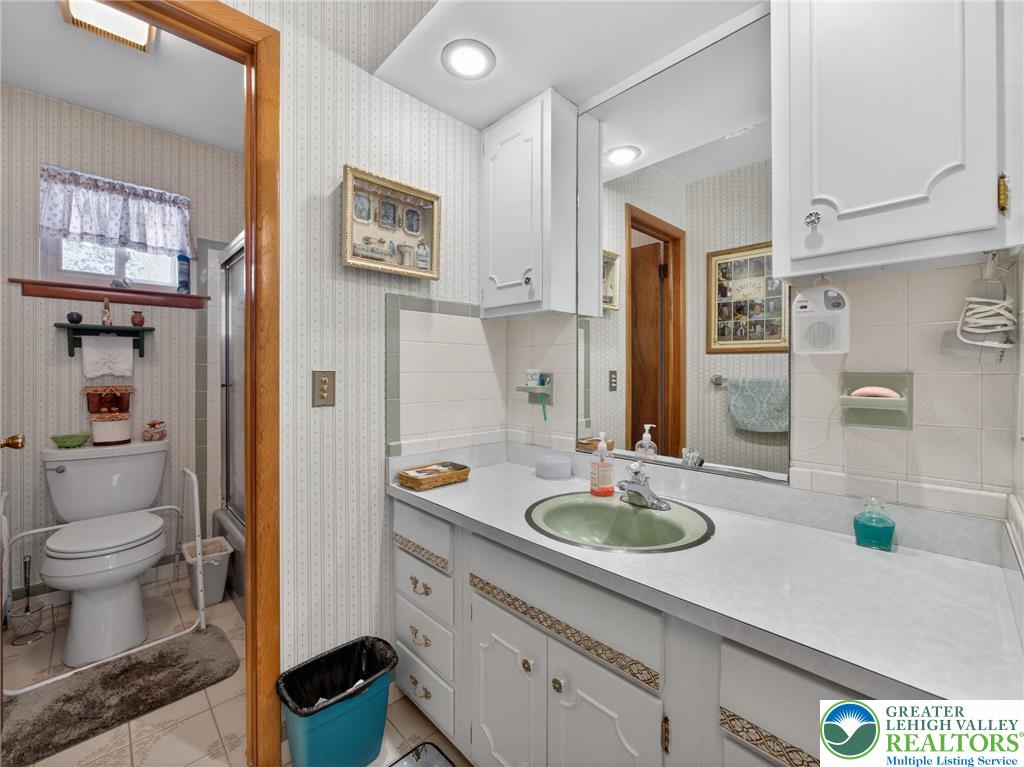 481 Forrest Avenue Bethlehem, PA 18017 - Photo 17 of 32 a spacious bathroom with a granite countertop sink and a mirror