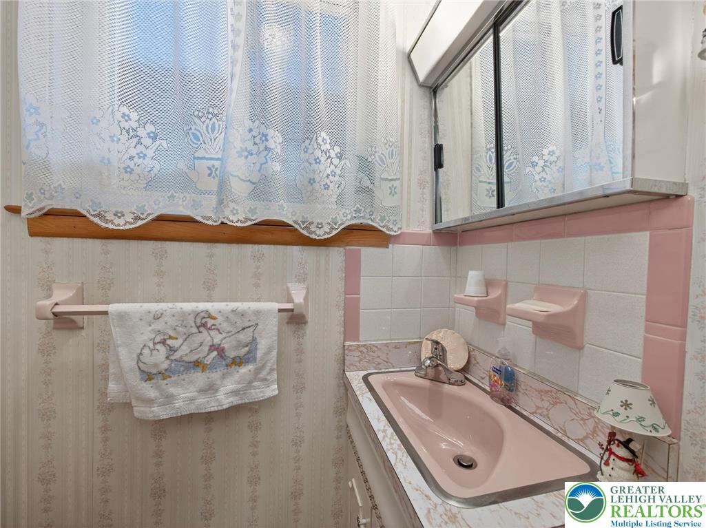 481 Forrest Avenue Bethlehem, PA 18017 - Photo 19 of 32 a bathroom with a sink a mirror and a sink