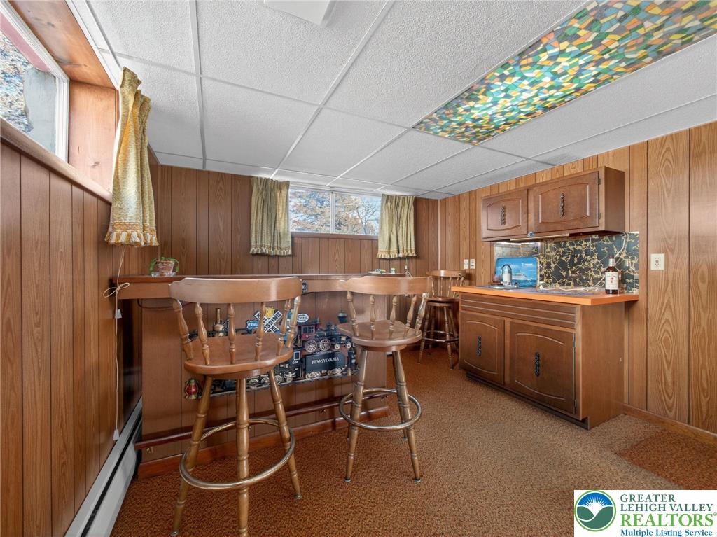 481 Forrest Avenue Bethlehem, PA 18017 - Photo 23 of 32 a kitchen with granite countertop a table chairs stove and cabinets