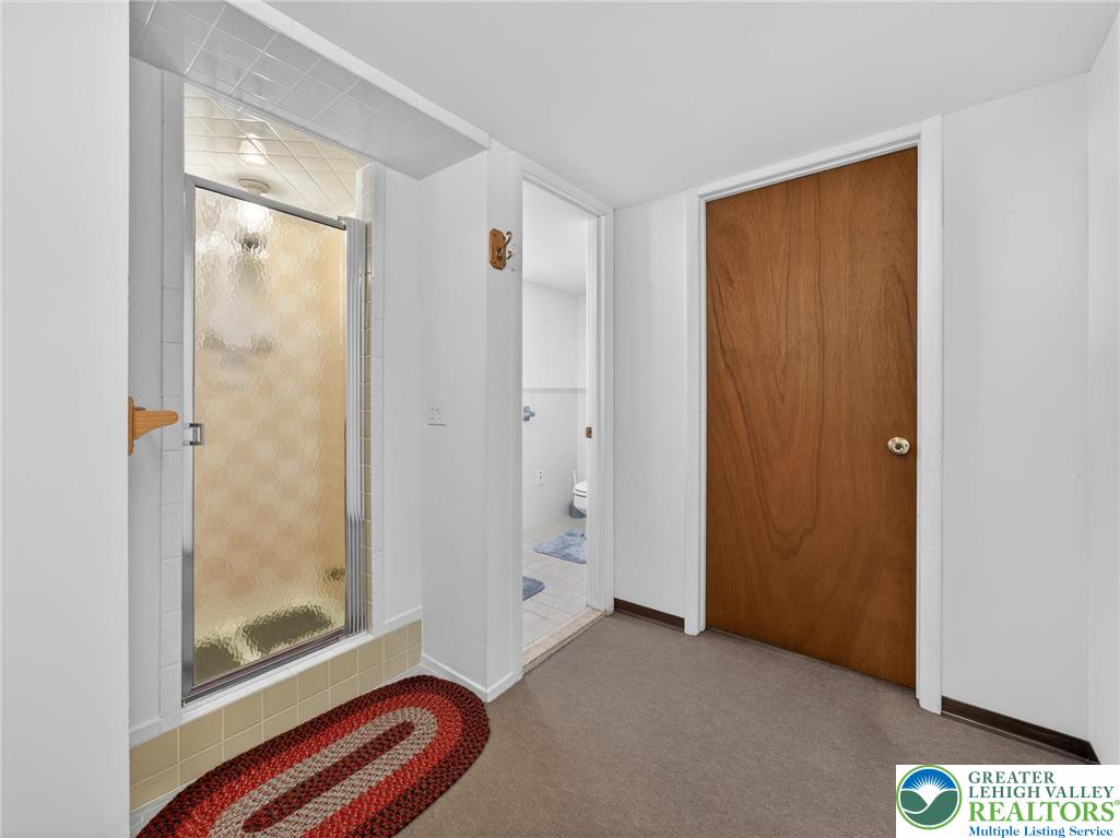 481 Forrest Avenue Bethlehem, PA 18017 - Photo 25 of 32 a bathroom with a glass shower door and a window