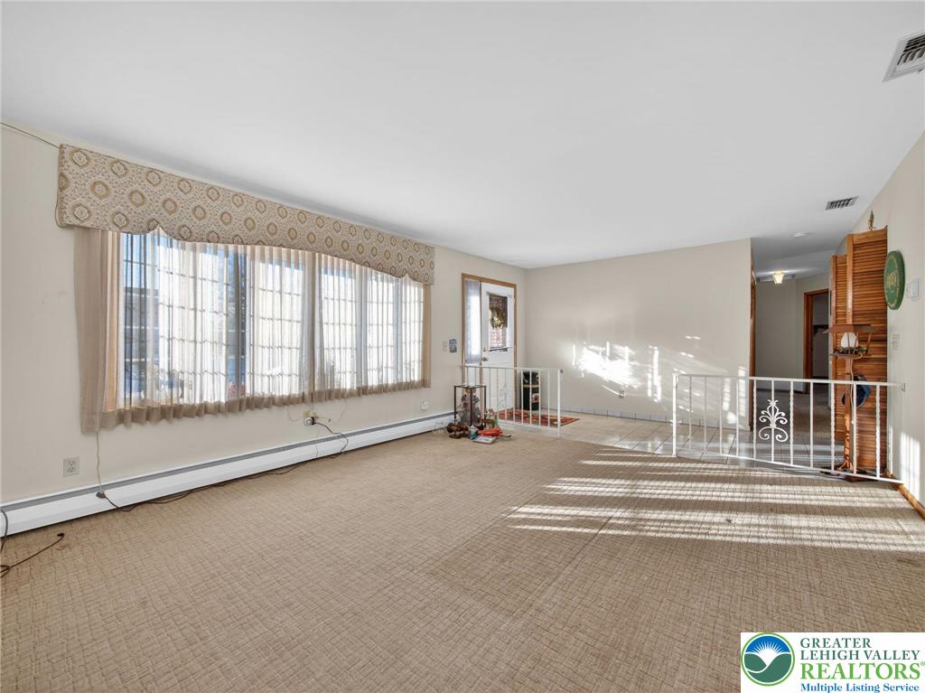 481 Forrest Avenue Bethlehem, PA 18017 - Photo 6 of 32 a view of an empty room with a fireplace and a large window