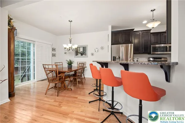 a kitchen with stainless steel appliances granite countertop a refrigerator stove and microwave