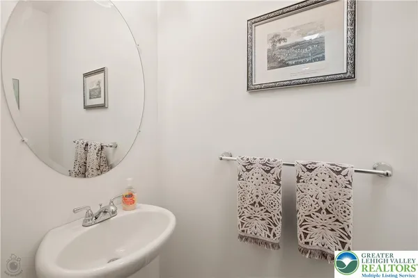 a bathroom with a double vanity sink toilet and a mirror