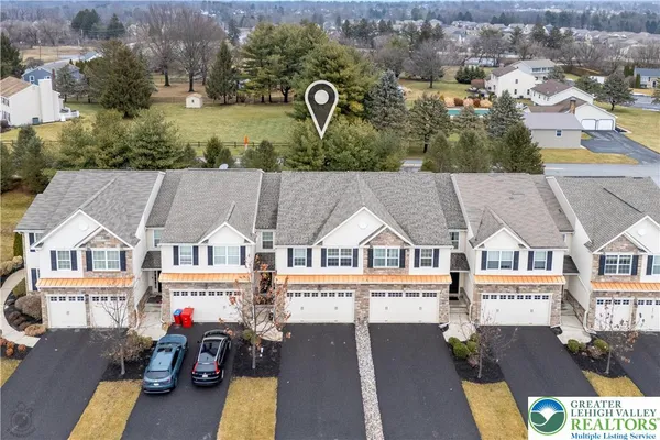 an aerial view of a house with parking space