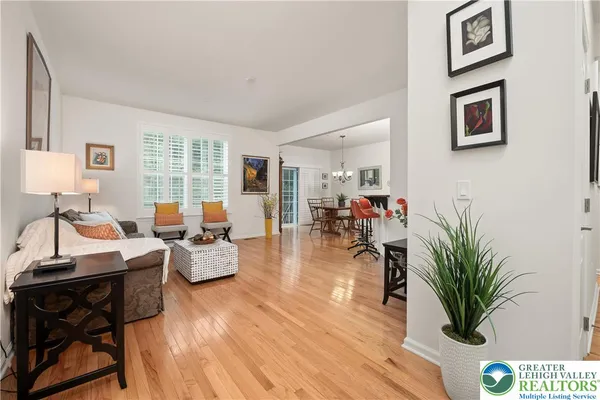 a dining room filled chandelier and wooden floor