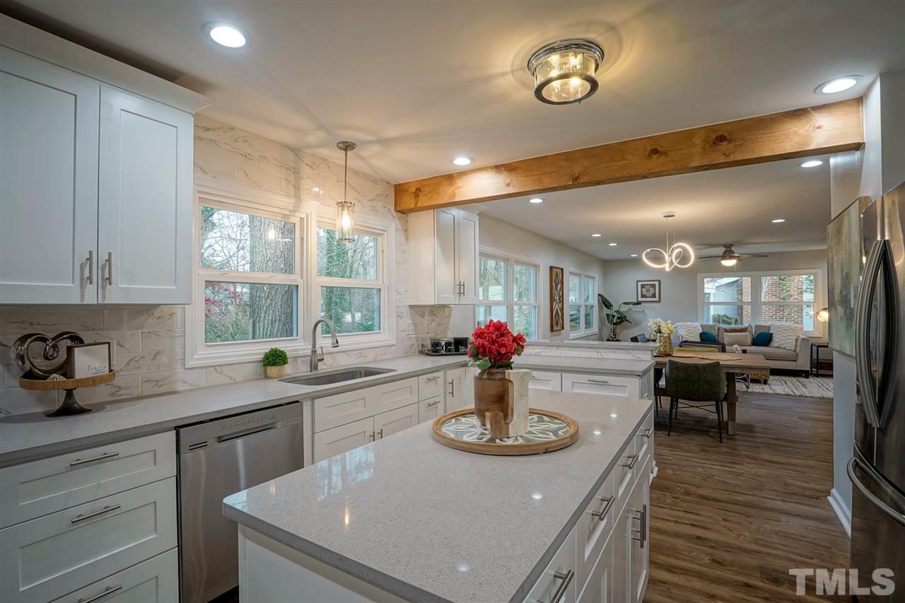 1105 Paddock Drive Raleigh, NC 27609 - Photo 11 of 30 a kitchen with a sink a stove and chairs