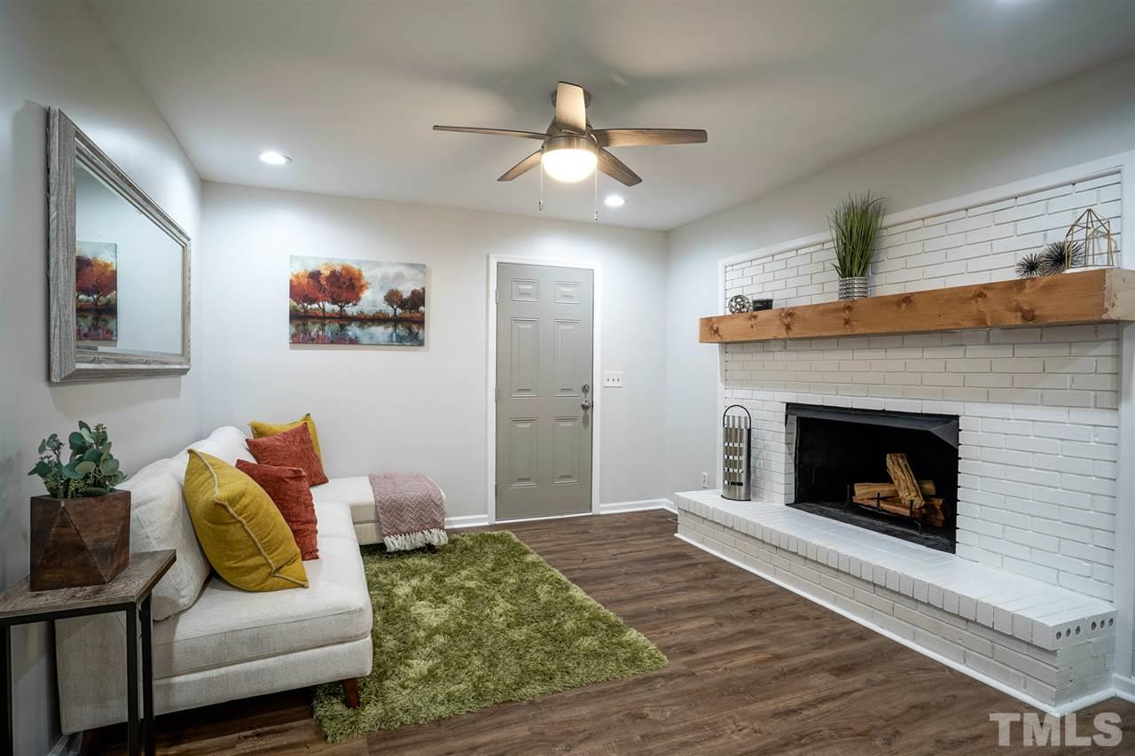 1105 Paddock Drive Raleigh, NC 27609 - Photo 18 of 30 a living room with furniture and a fireplace