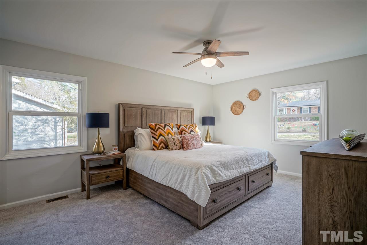 1105 Paddock Drive Raleigh, NC 27609 - Photo 22 of 30 a bedroom with a bed dresser and a window