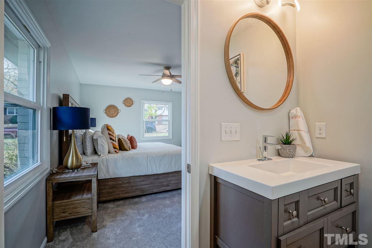 1105 Paddock Drive Raleigh, NC 27609 - Photo 24 of 30 a en suite bathroom with a sink and a mirror