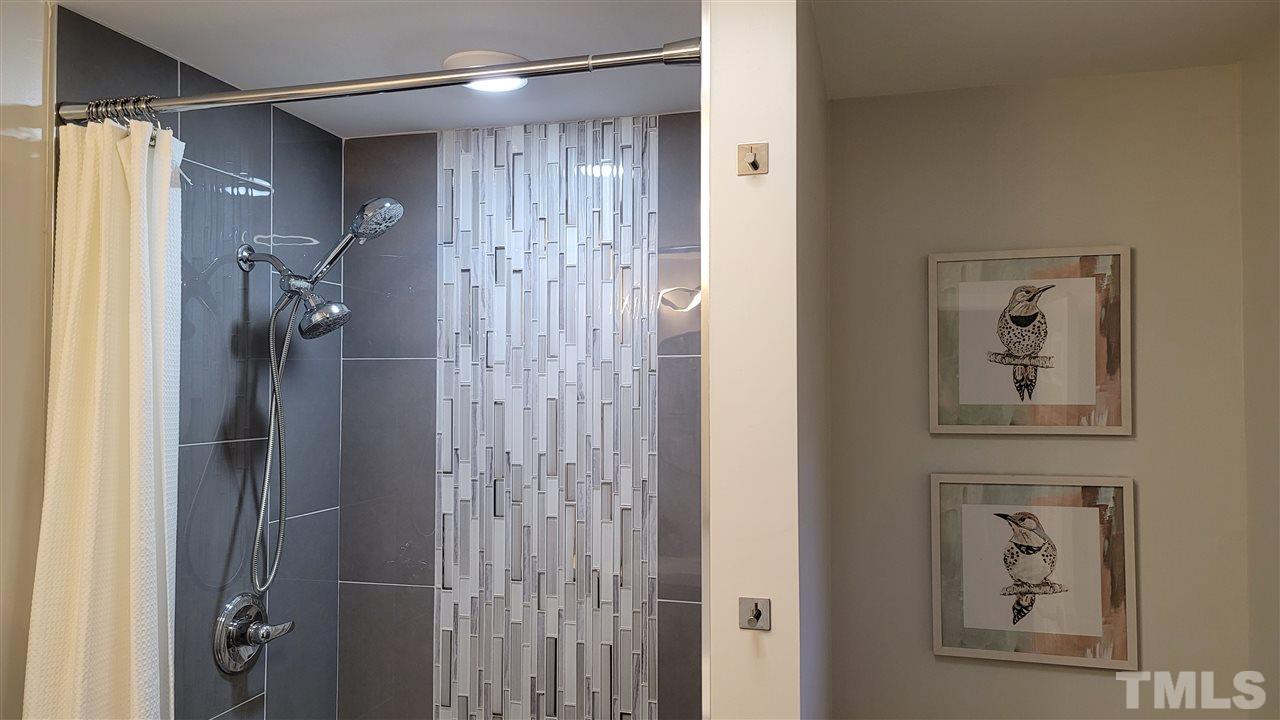 1105 Paddock Drive Raleigh, NC 27609 - Photo 25 of 30 a bathroom with a shower and a sink