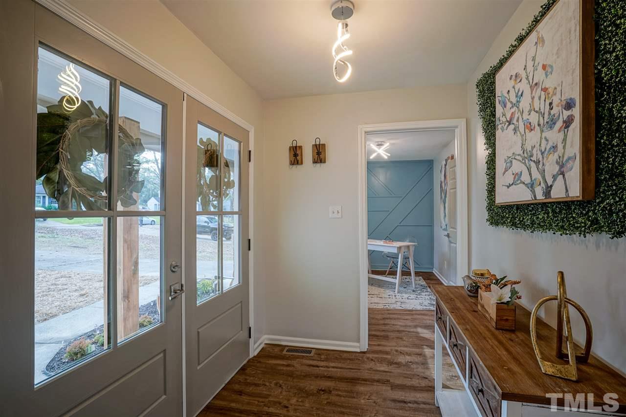 1105 Paddock Drive Raleigh, NC 27609 - Photo 6 of 30 a view of a hallway with furniture and front door