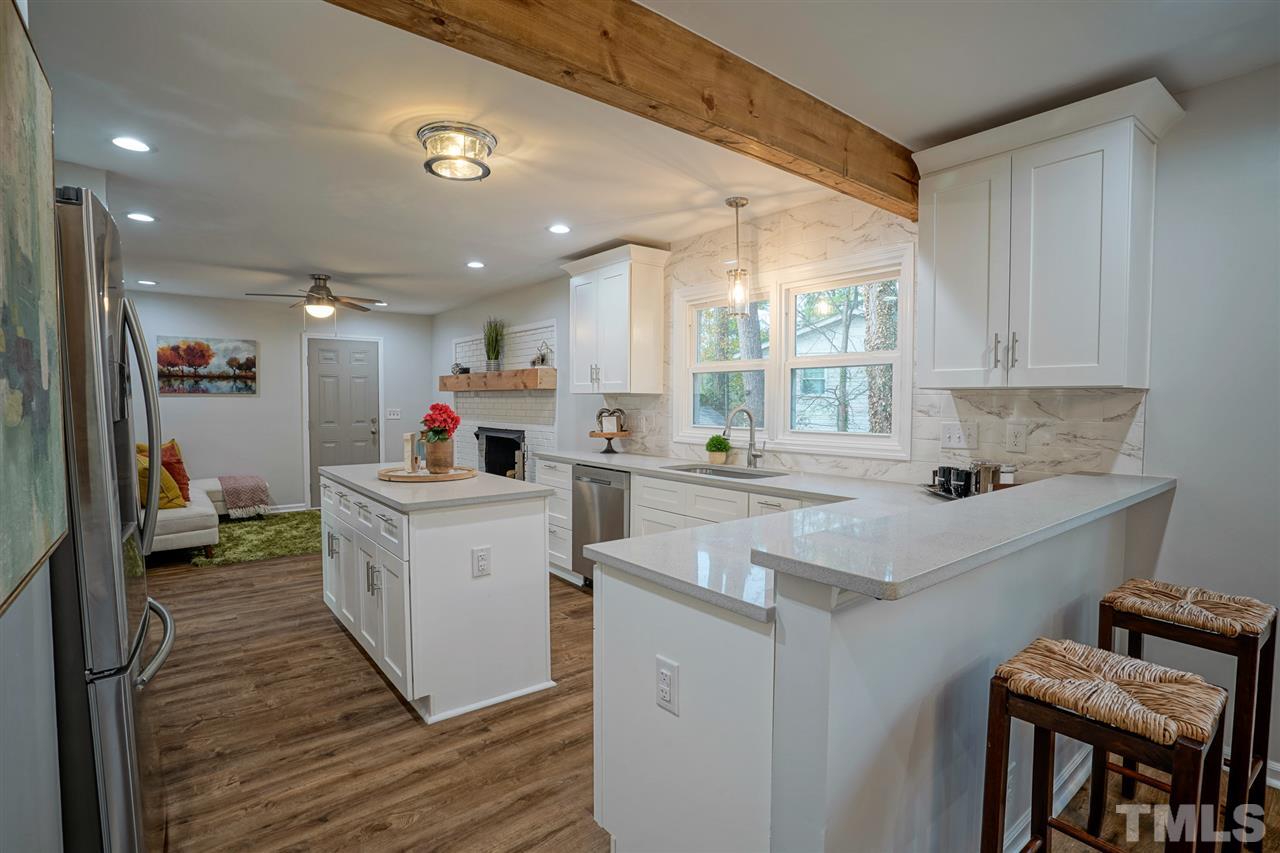 1105 Paddock Drive Raleigh, NC 27609 - Photo 10 of 30 a kitchen with a sink cabinets and window