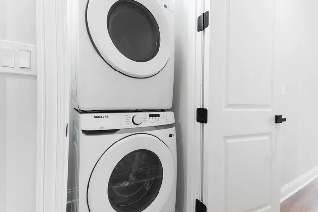 a close view of a utility room with dryer and washer
