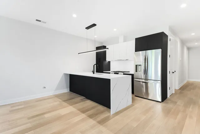 a kitchen with stainless steel appliances a refrigerator and a stove