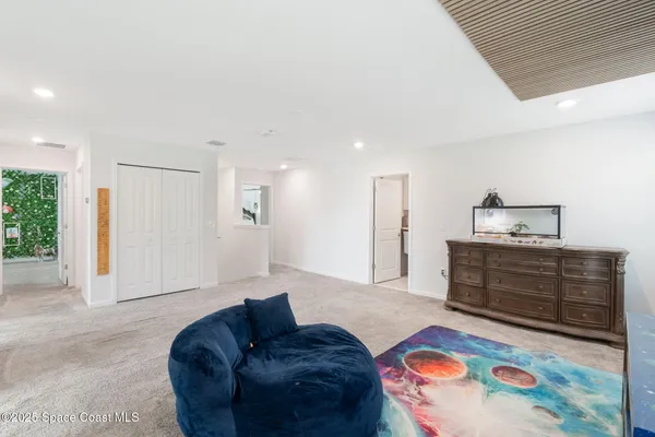 a bedroom with a bed and a ceiling fan