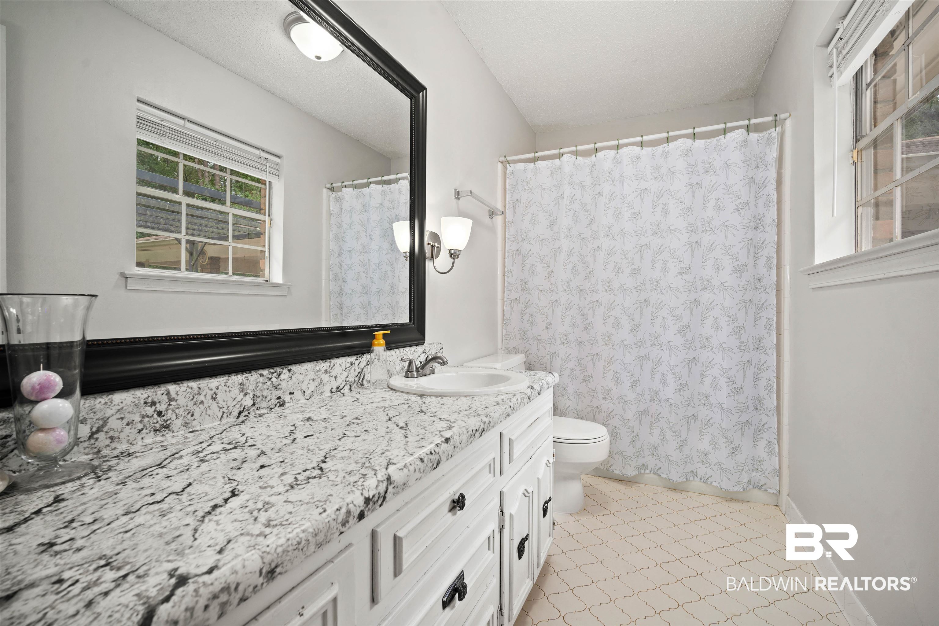 7807 Yorkhaven Road Mobile, AL 36695 - Photo 17 of 34 Bathroom featuring curtained shower, vanity, and light tile patterned floors