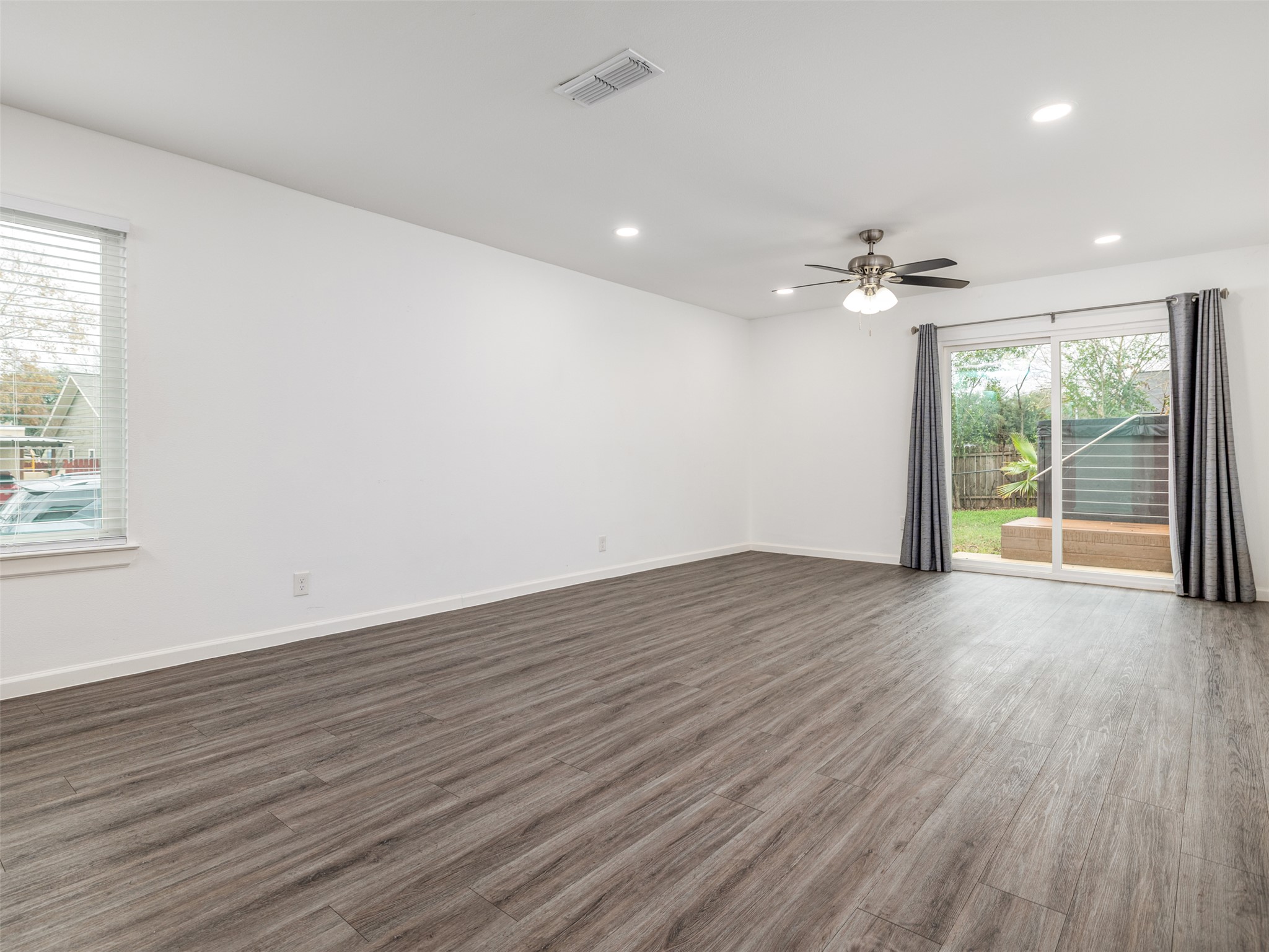 711 Buckingham Place Austin, TX 78745 - Photo 11 of 25 Spare room featuring wood finished floors, ceiling fan, and recessed lighting