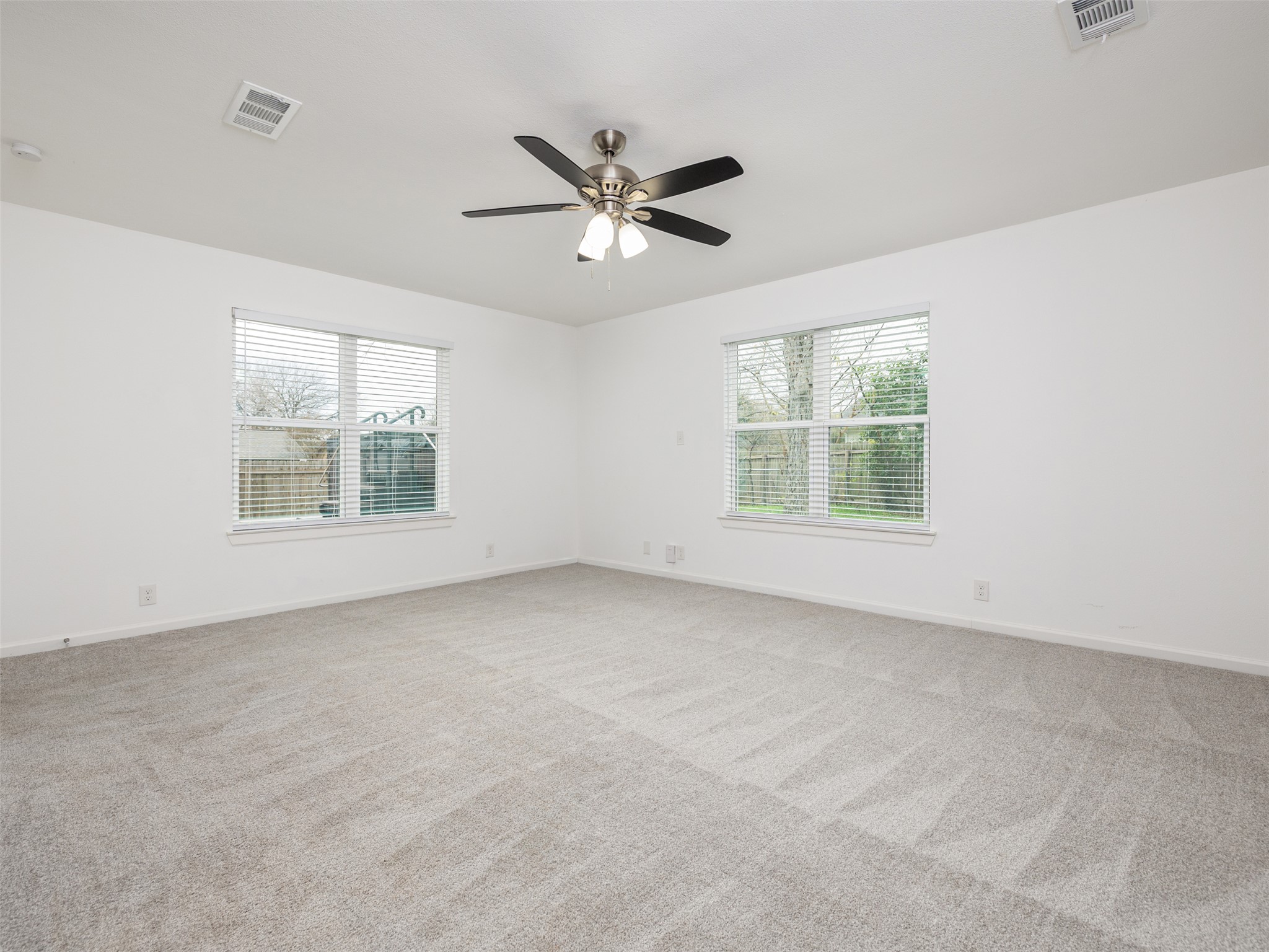 711 Buckingham Place Austin, TX 78745 - Photo 14 of 25 Primary bedroom with plenty of natural light and ceiling fan