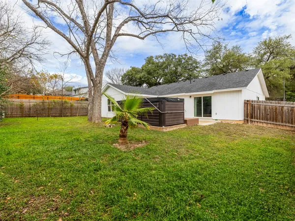 a backyard of a house with table and chairs