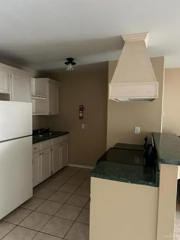 a kitchen with a sink and a refrigerator