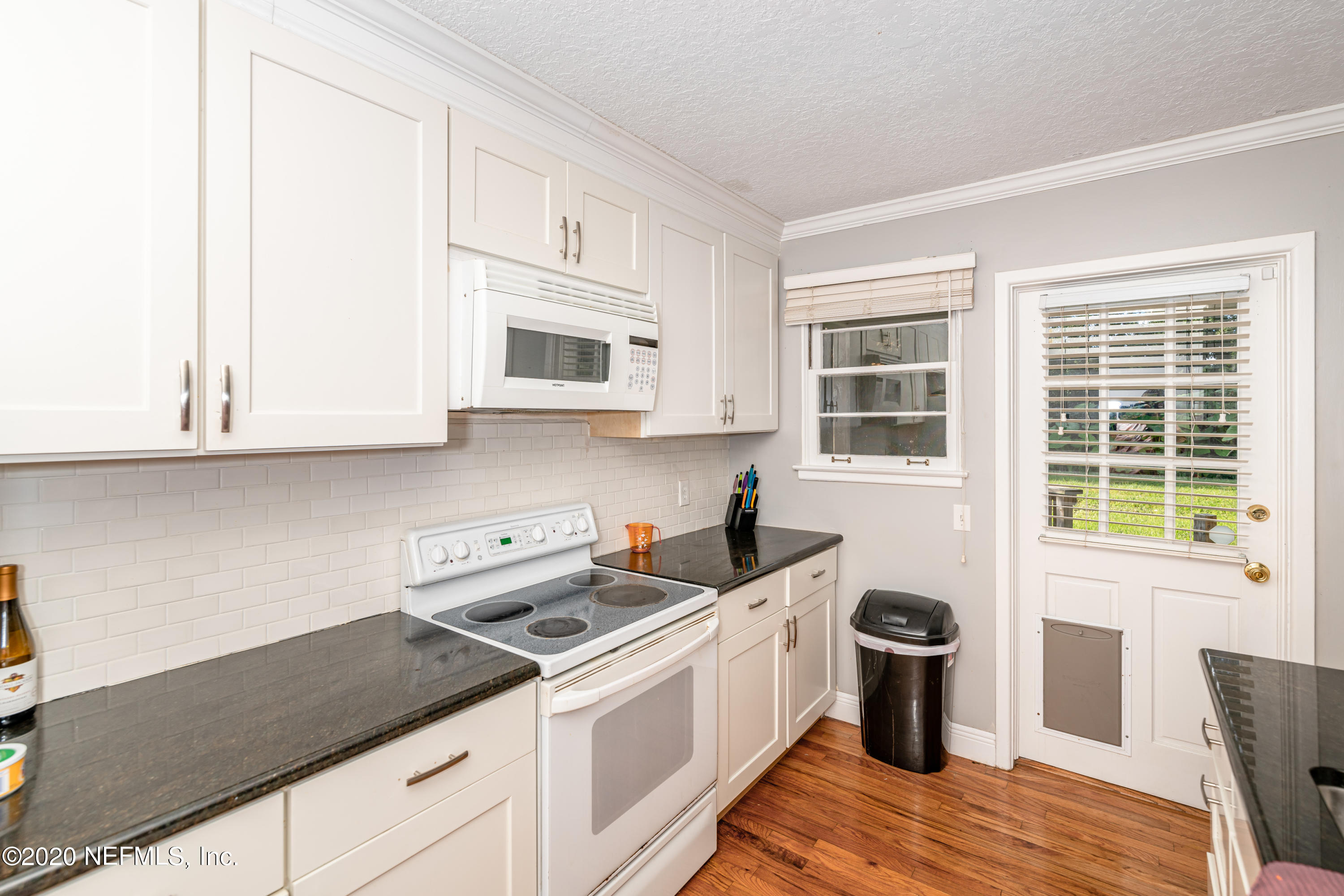 4615 Homestead Road Jacksonville, FL 32210 - Photo 12 of 41 a kitchen with stainless steel appliances granite countertop a stove a sink and a microwave