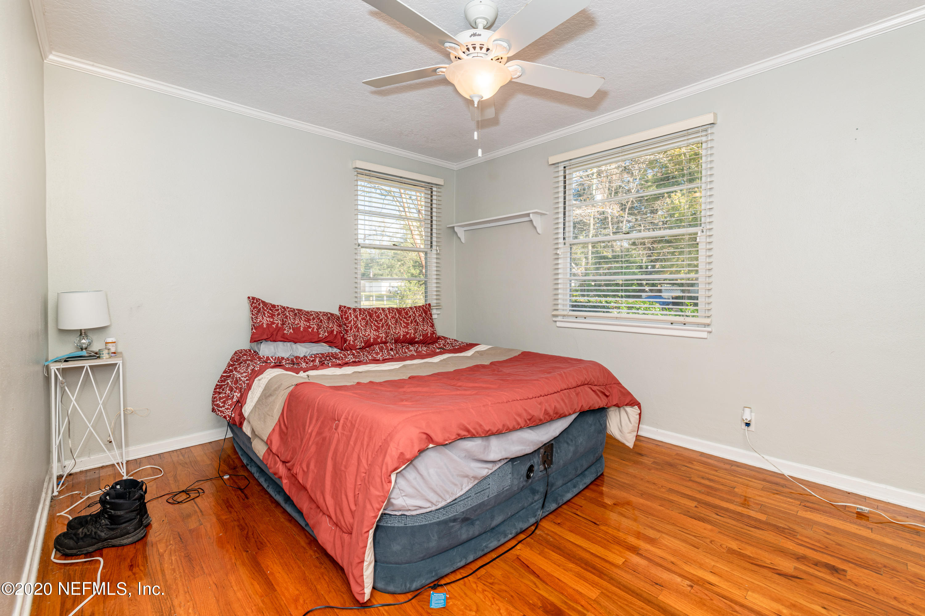 4615 Homestead Road Jacksonville, FL 32210 - Photo 17 of 41 a bed sitting in a bedroom next to a window