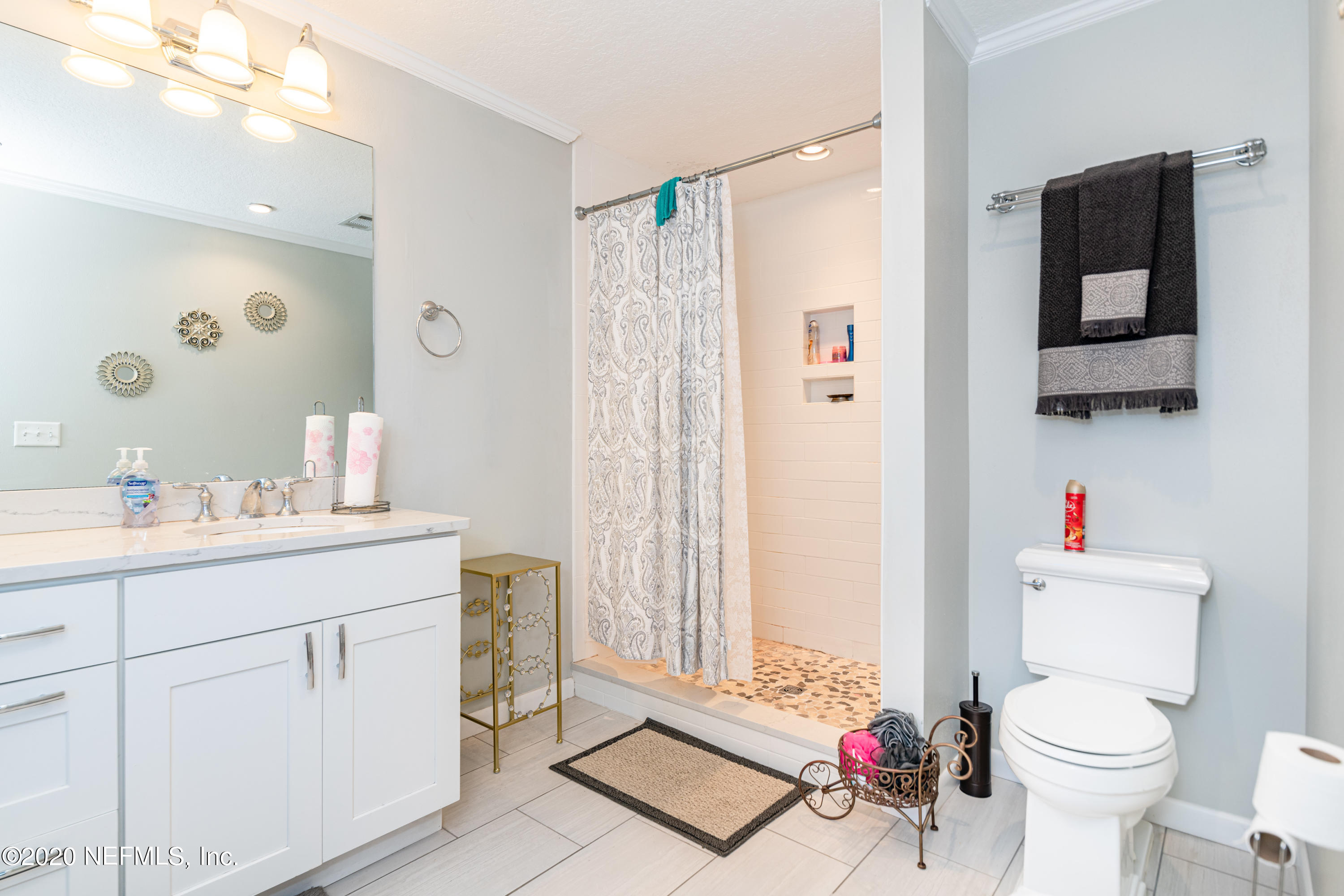4615 Homestead Road Jacksonville, FL 32210 - Photo 19 of 41 a bathroom with a sink mirror vanity and toilet