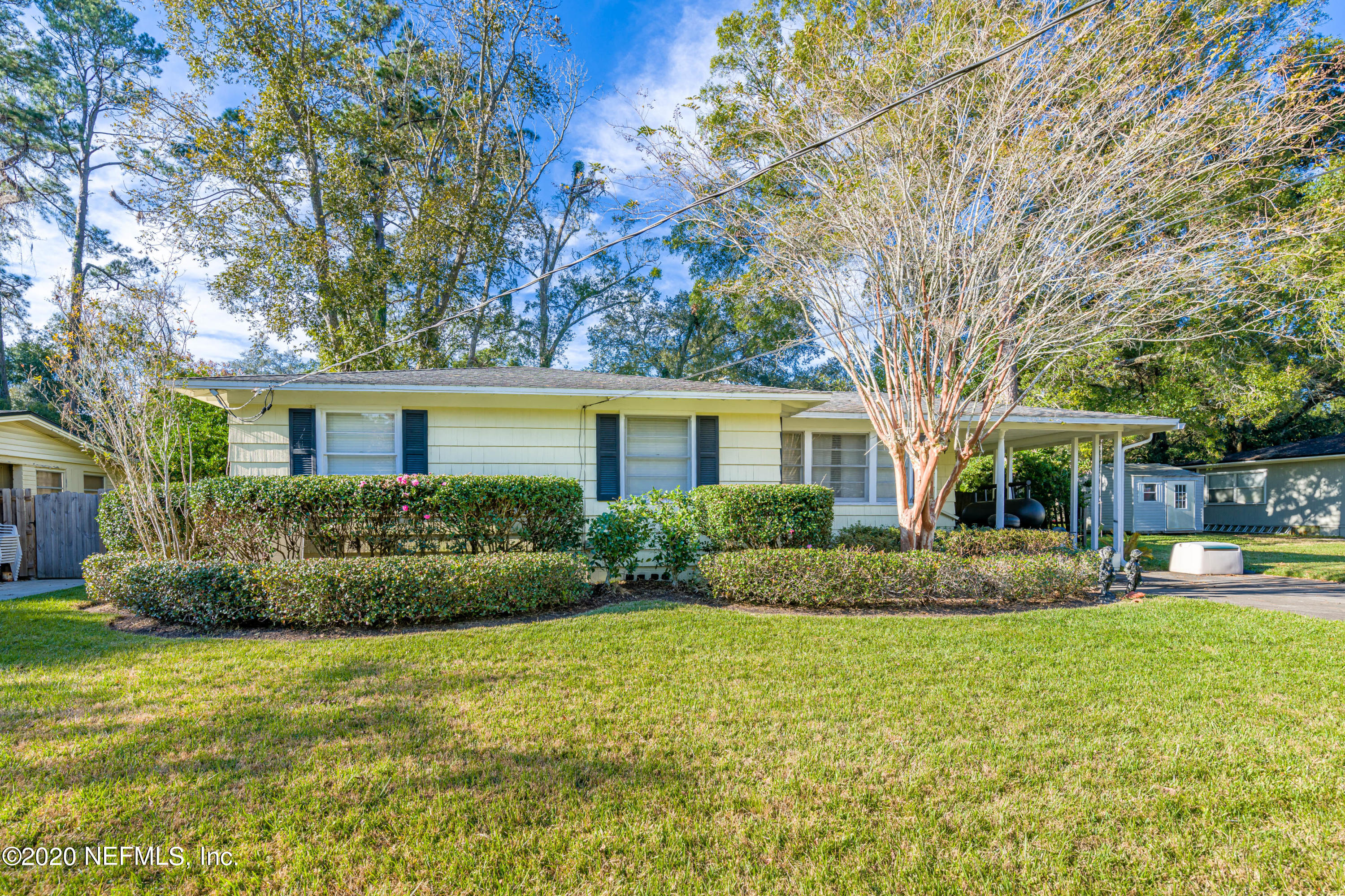 4615 Homestead Road Jacksonville, FL 32210 - Photo 2 of 41 a front view of a house with a yard and trees