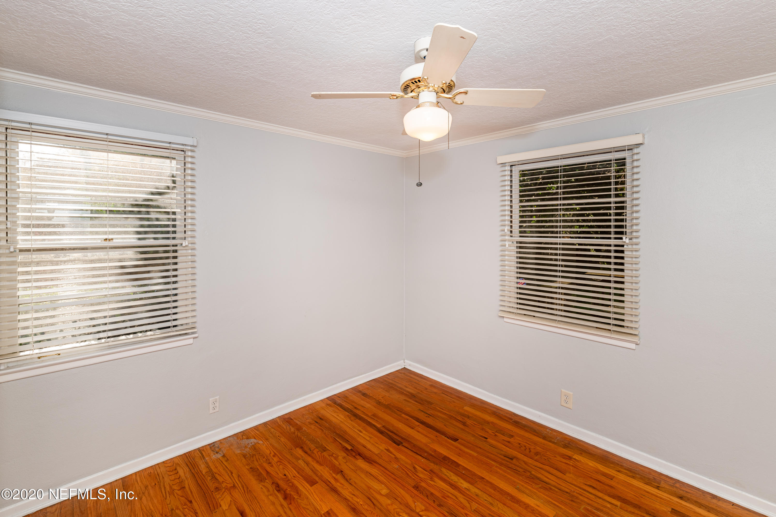 4615 Homestead Road Jacksonville, FL 32210 - Photo 25 of 41 a view of an empty room with wooden floor and a window