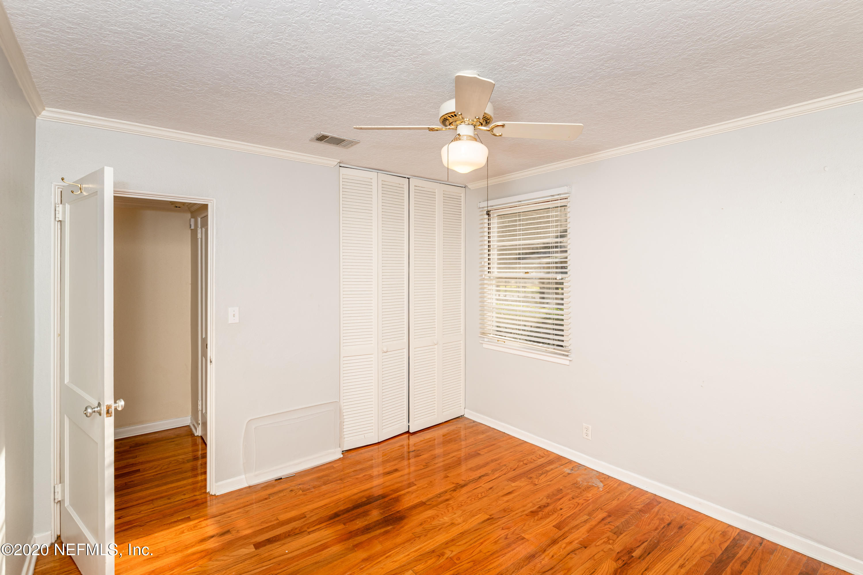 4615 Homestead Road Jacksonville, FL 32210 - Photo 26 of 41 a view of an empty room with wooden floor and a window