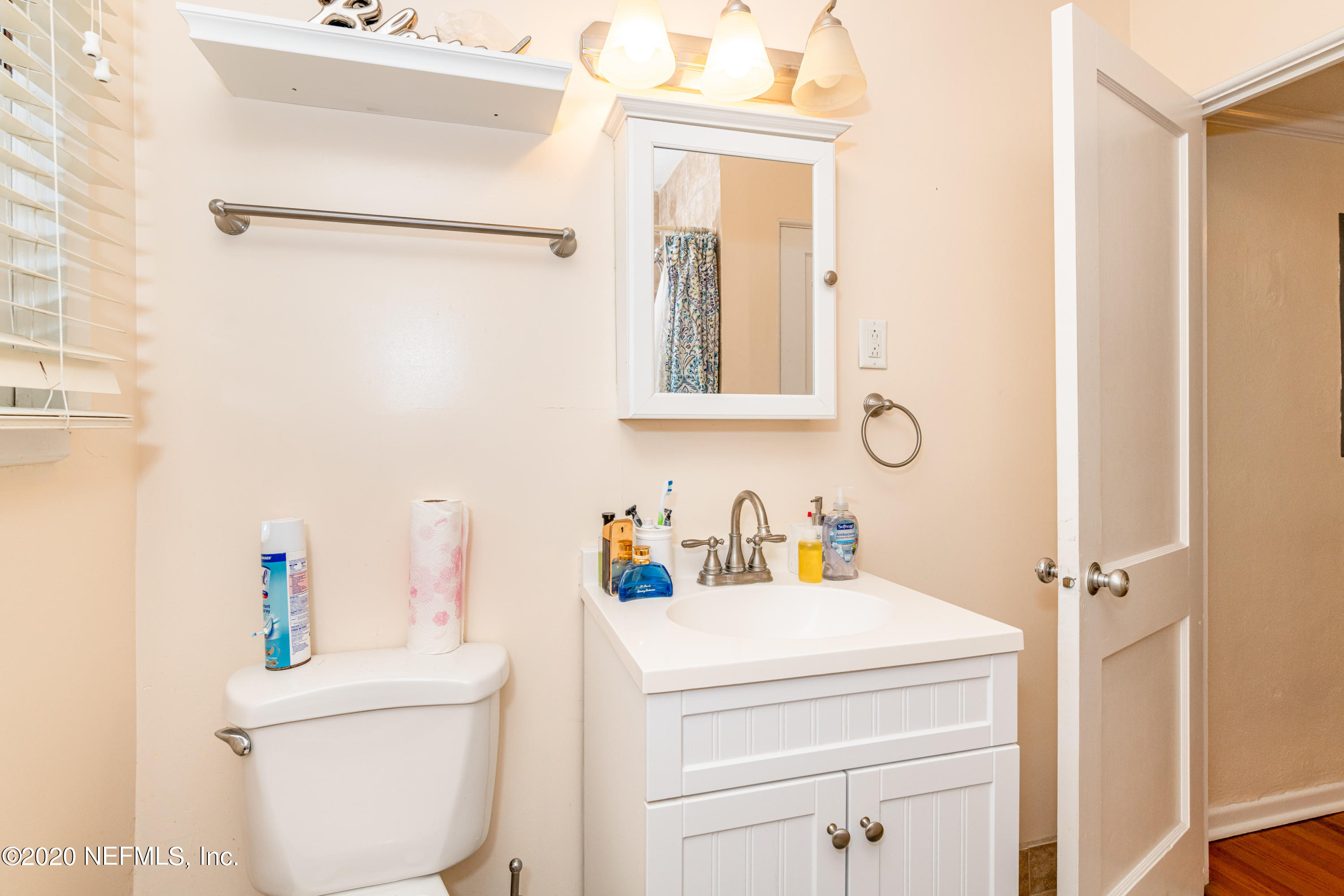 4615 Homestead Road Jacksonville, FL 32210 - Photo 29 of 41 a bathroom with a sink a toilet and a mirror