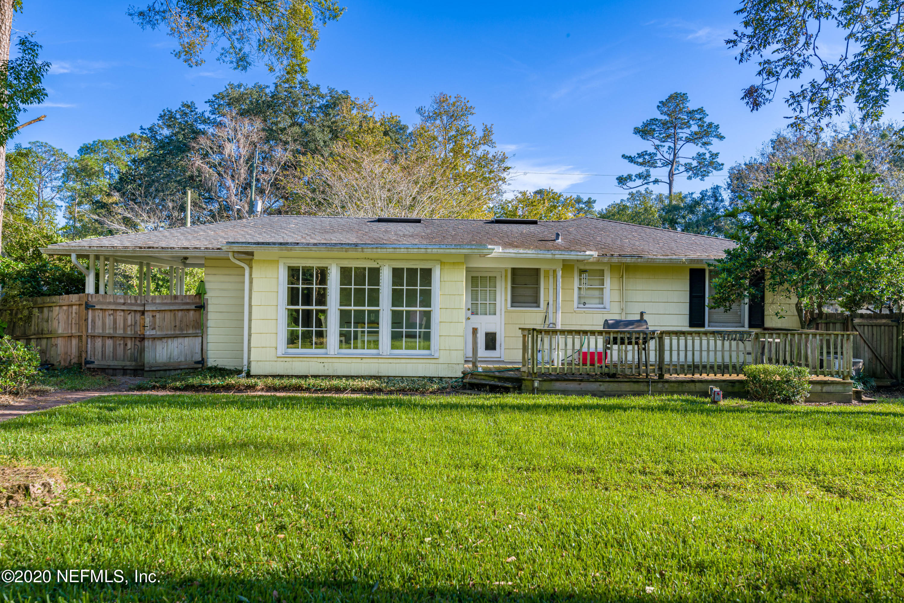 4615 Homestead Road Jacksonville, FL 32210 - Photo 35 of 41 a front view of a house with a yard table and chairs