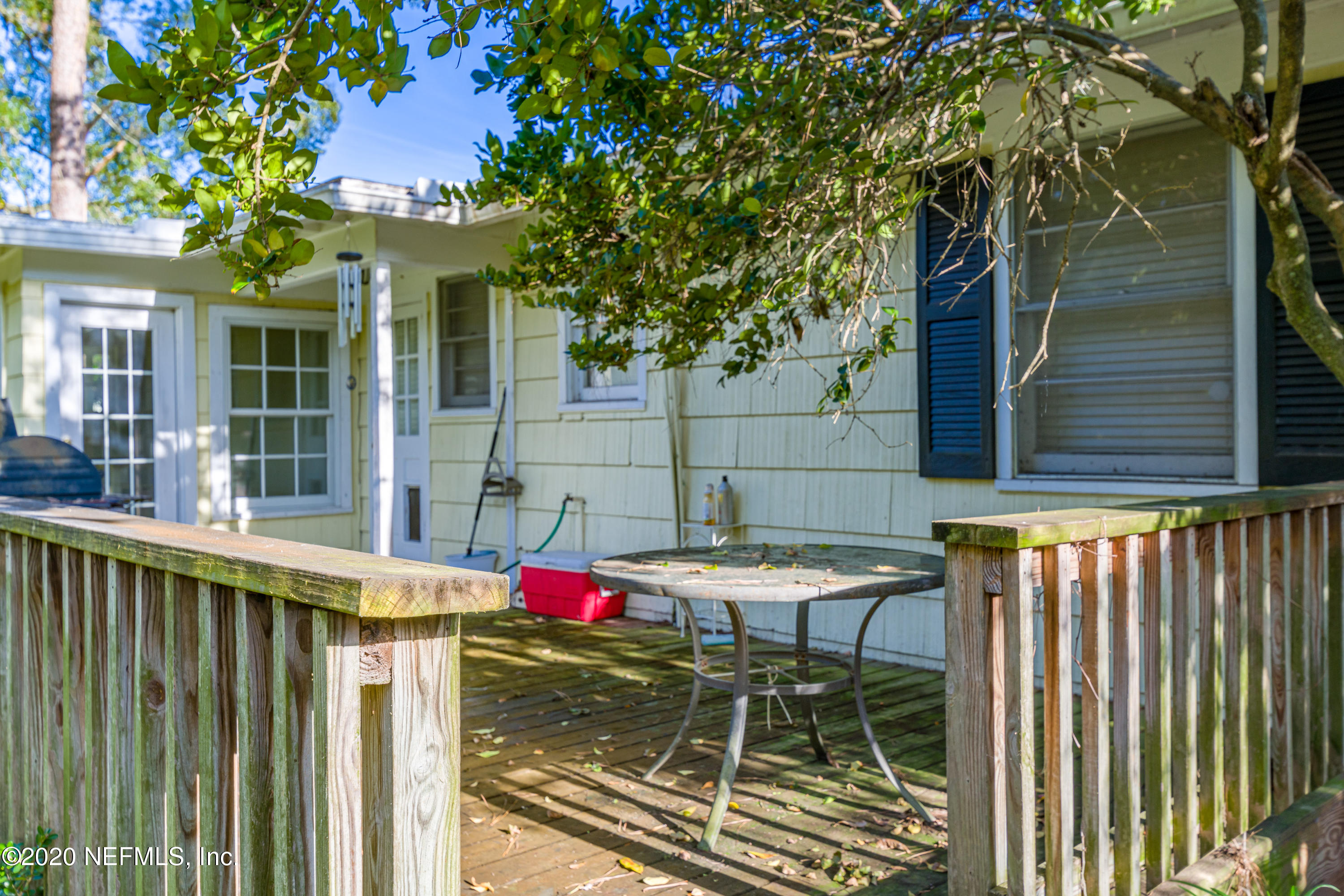 4615 Homestead Road Jacksonville, FL 32210 - Photo 38 of 41 a view of a patio with table and chairs and wooden fence