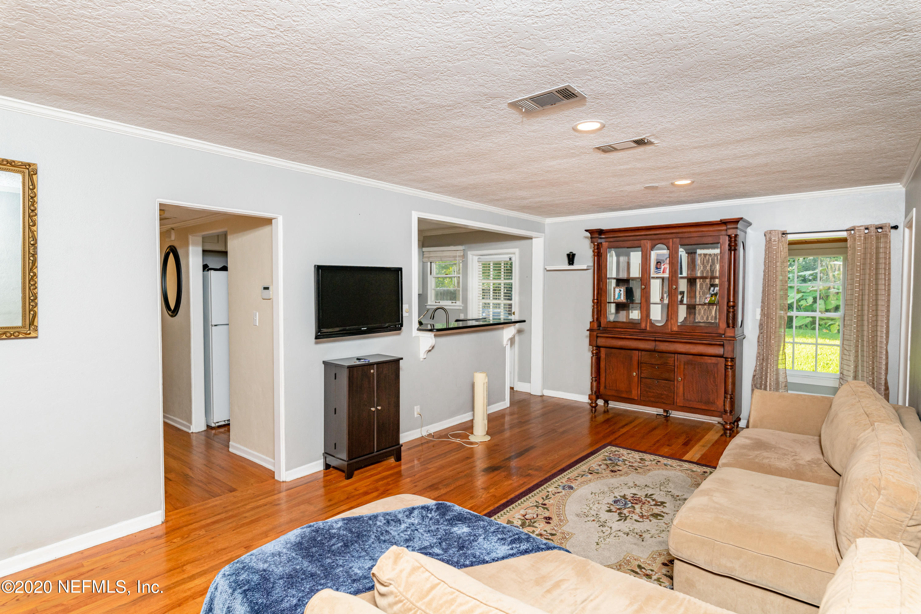 4615 Homestead Road Jacksonville, FL 32210 - Photo 5 of 41 a living room with furniture and a flat screen tv