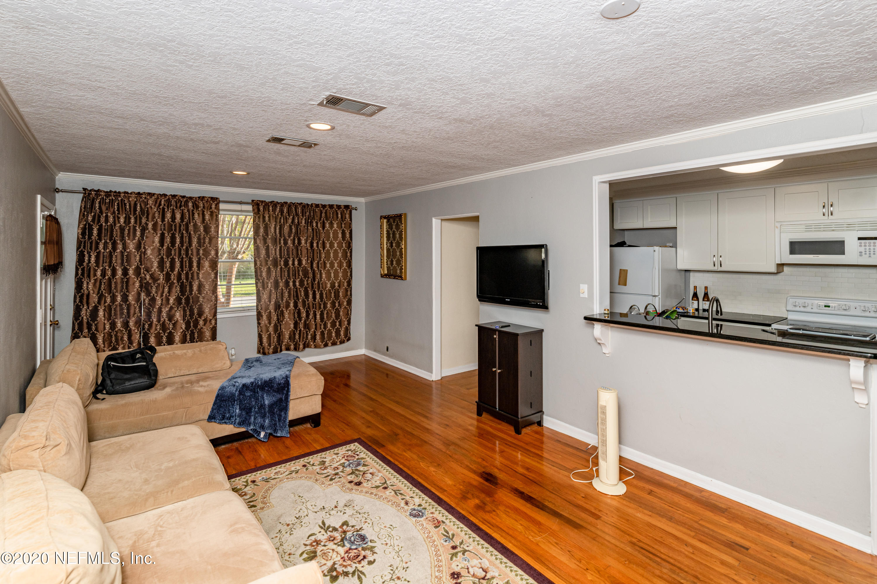 4615 Homestead Road Jacksonville, FL 32210 - Photo 9 of 41 a living room with furniture and a flat screen tv
