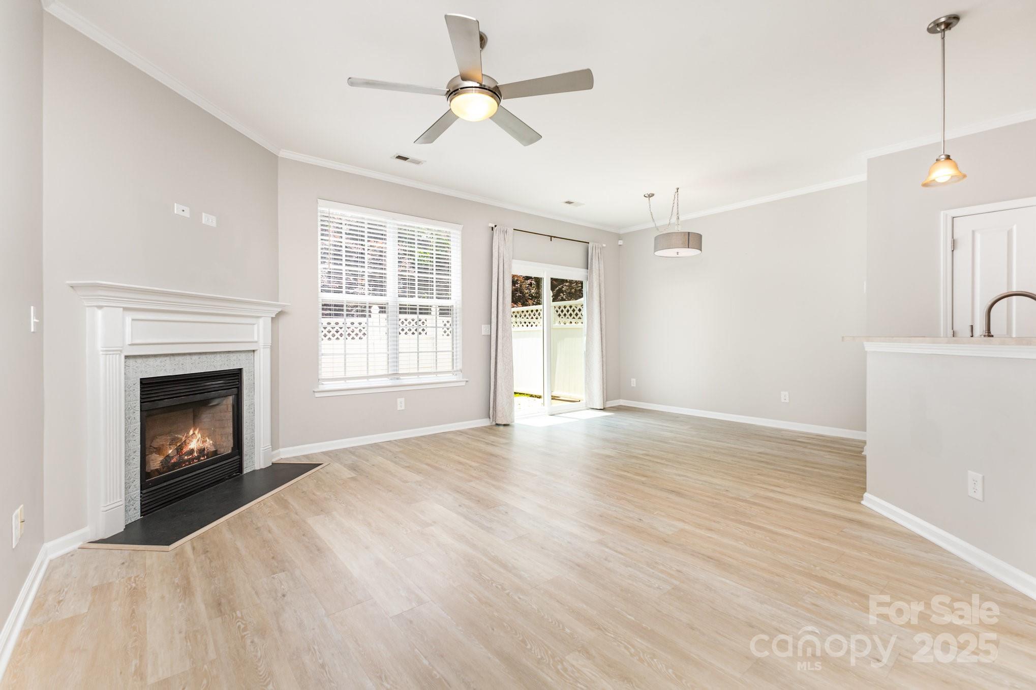 230 Dawn Mist Lane Fort Mill, SC 29708 - Photo 8 of 34 a view of empty room with wooden floor and fireplace
