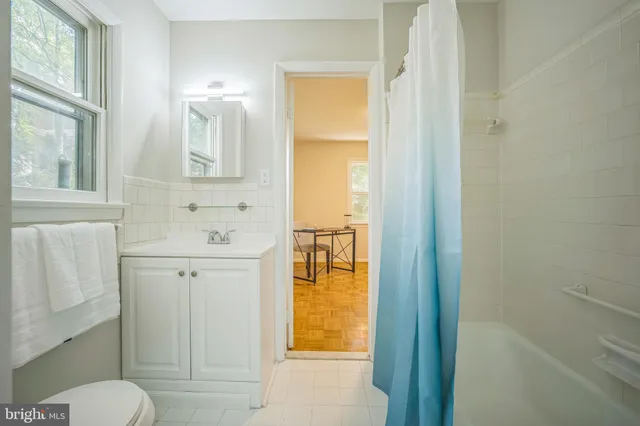 a bathroom with a sink and mirror with toilet