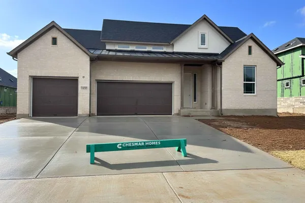 a front view of a house with garage