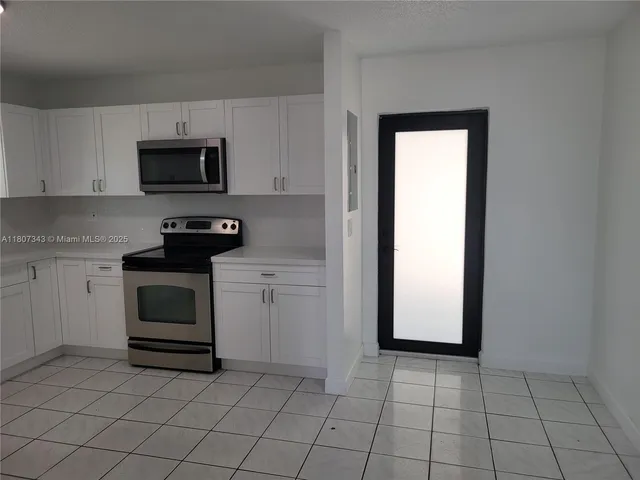 a kitchen with a stove and a refrigerator
