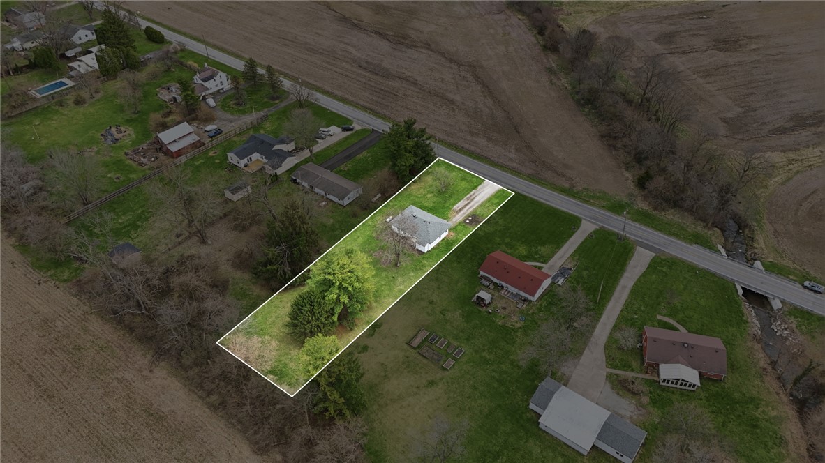 1166 West Sparrow Road Springfield, OH 45502 - Photo 3 of 40 An aerial view of a property with a house, driveway, and lush greenery.