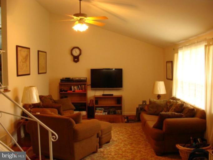 12818 Crisfield Road Silver Spring, MD 20906 - Photo 2 of 21 a living room with furniture and a flat screen tv
