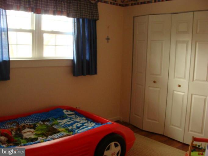 12818 Crisfield Road Silver Spring, MD 20906 - Photo 17 of 21 a room with a bed and a window